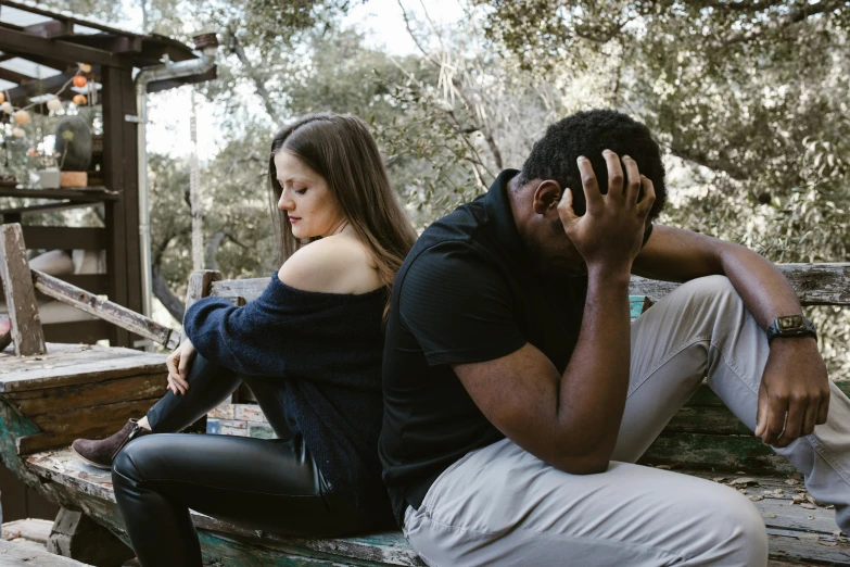 a man and a woman sitting on a bench