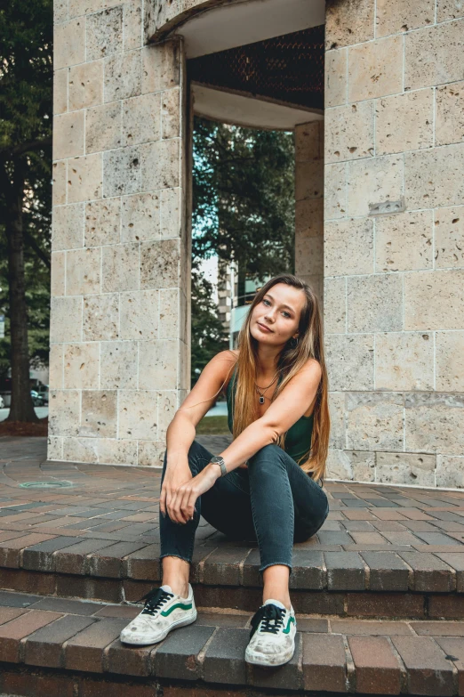 a girl sitting on some steps smiling