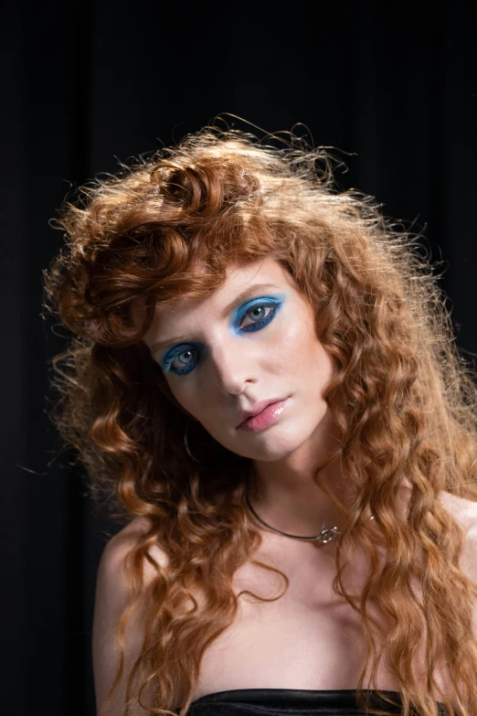 a beautiful young woman with blue eyes with curly hair