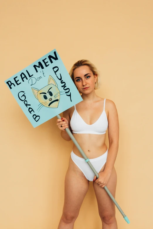 a woman with a  body holding a sign that reads repealing women