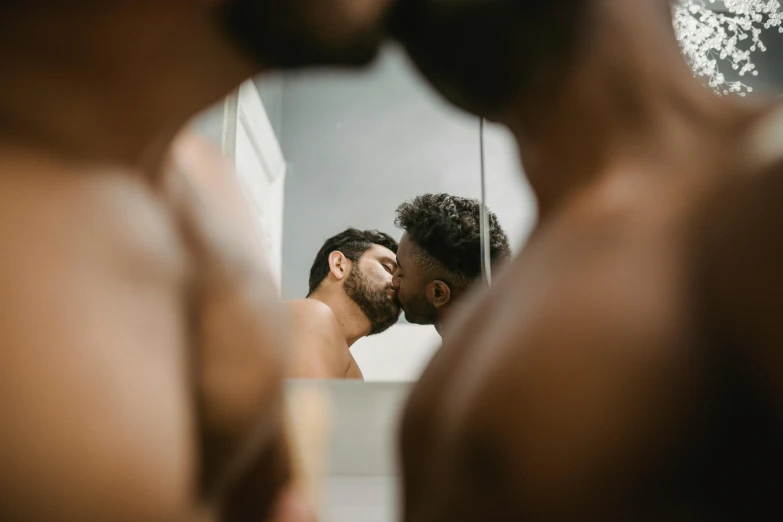 man taking selfie in mirror of bathroom