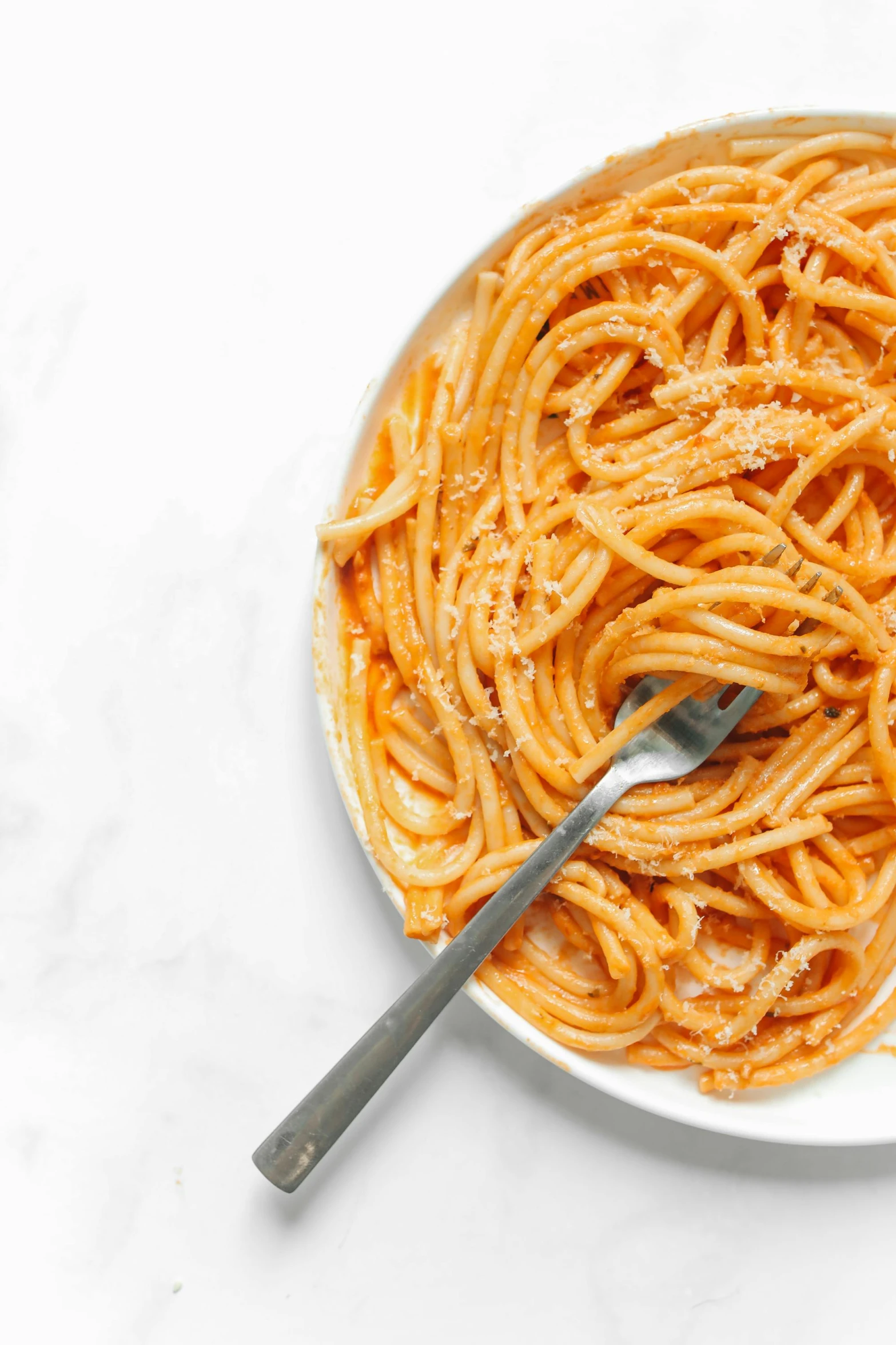 the pasta is tossed with parmesan cheese and ready to be eaten