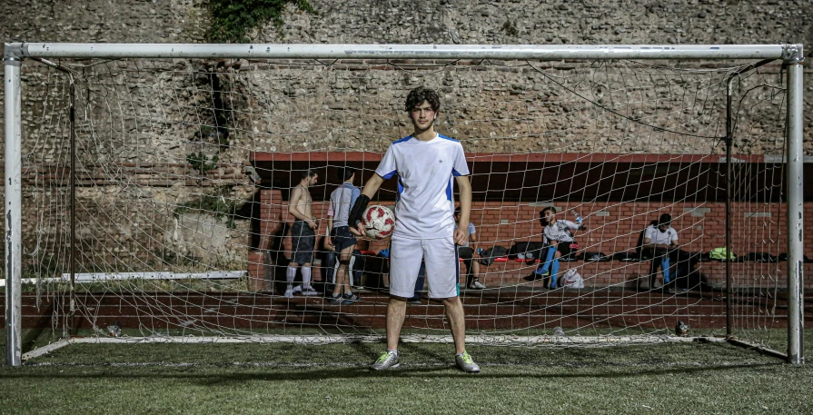 a man standing in front of a soccer goal