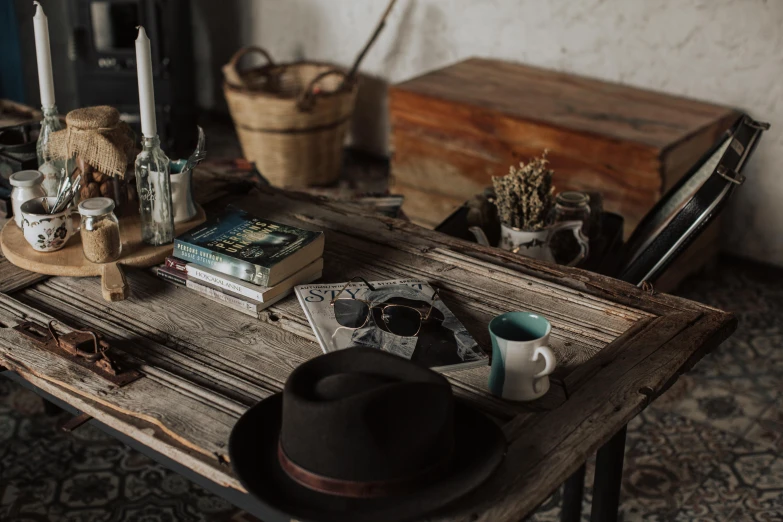 a table topped with books and two candles