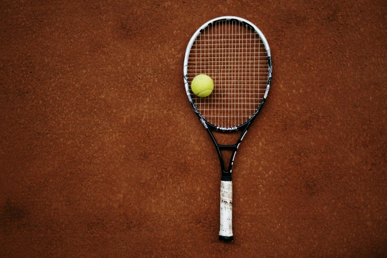 a tennis racket is resting on the court