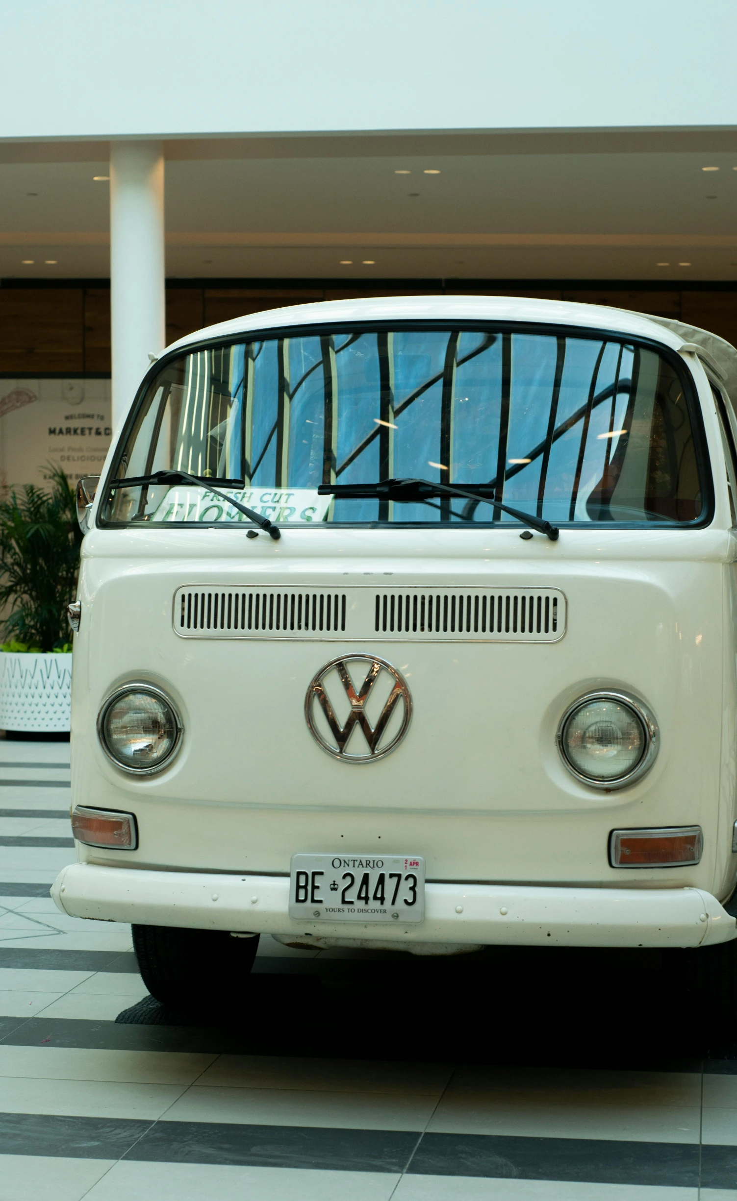 a volkswagen van sitting on a checkerboard parking lot