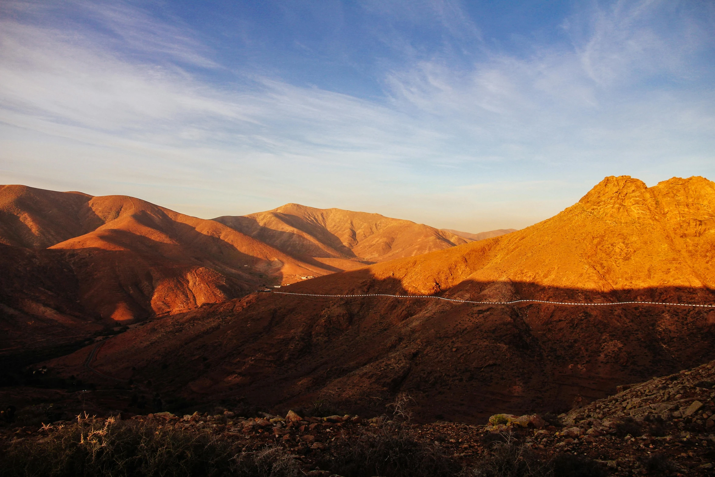 the mountains are shown from afar on a sunny day