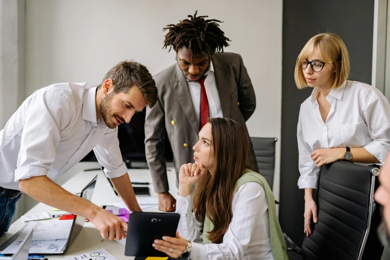 a man working with colleagues in an office