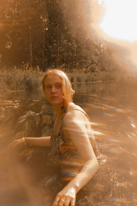 a woman sitting in the river water looking at soing