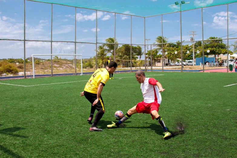 two men are on the field playing soccer