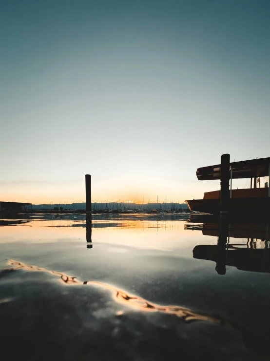 a large body of water with a dock in the background