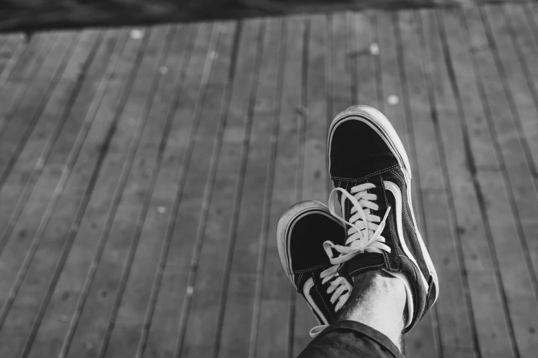 a pair of shoes are displayed on a boardwalk