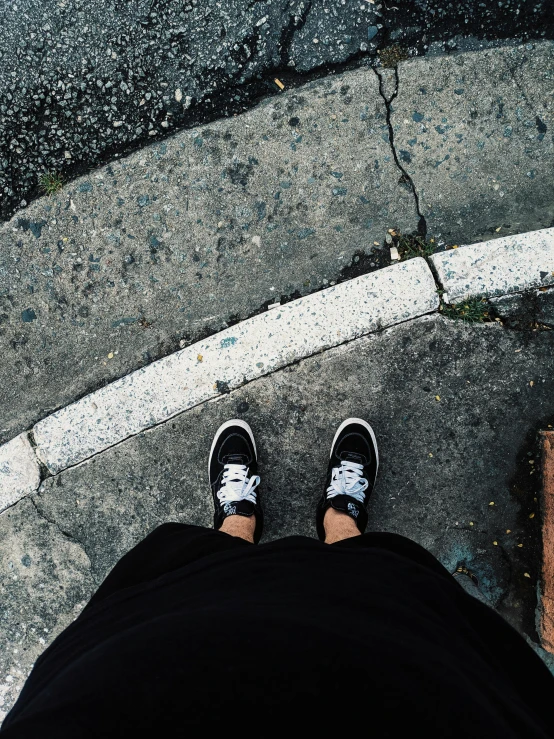 someone standing on concrete near a cross walk