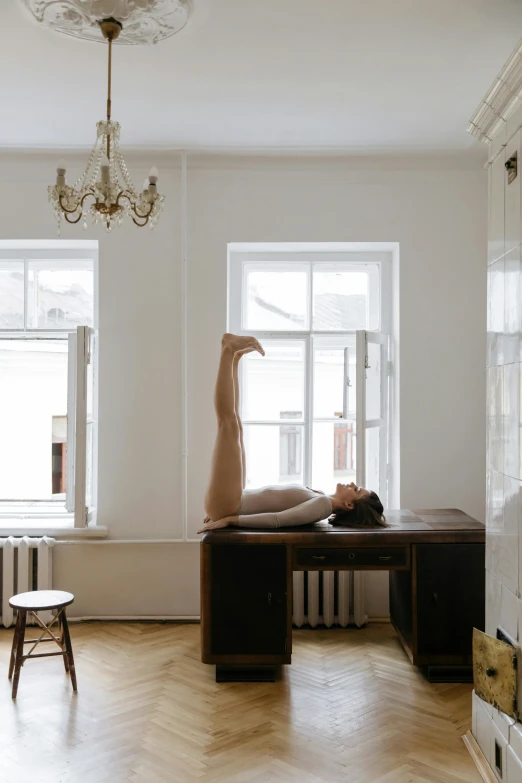 a woman's body is posed on the desk