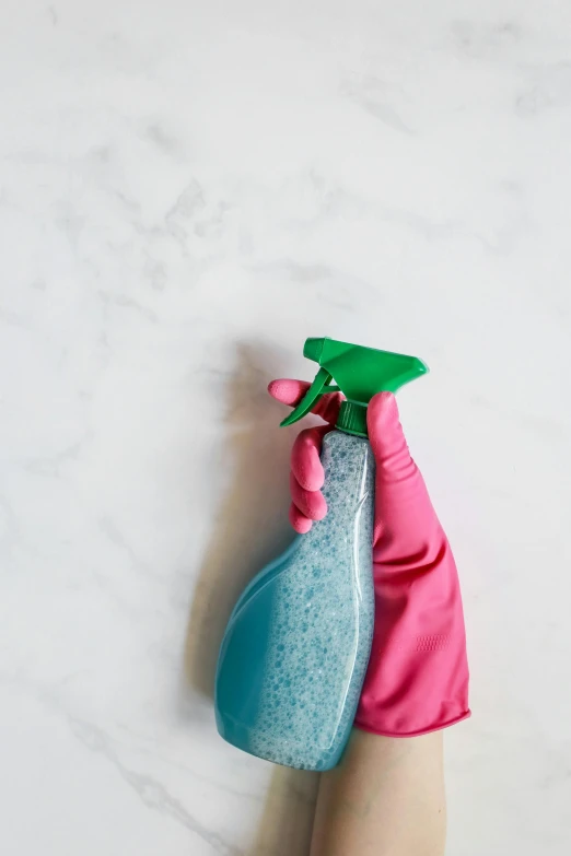 two different colors plastic cleaning products that are on a person's hands