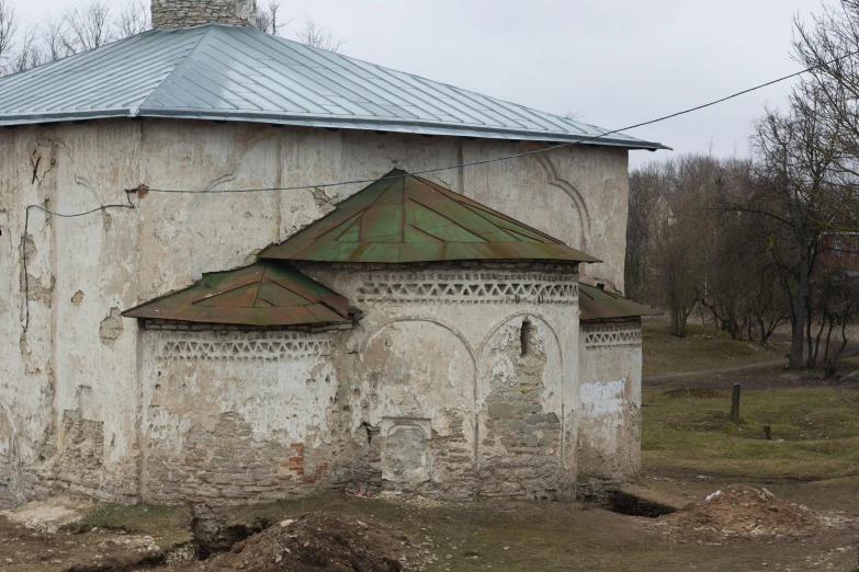 a worn out structure with a clock on it