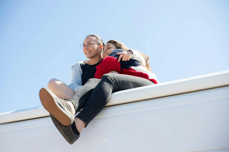 a man and woman sitting on the back of a truck together