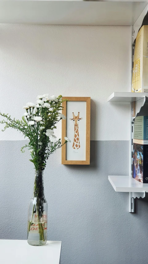 the flowers are in a vase near a book shelf