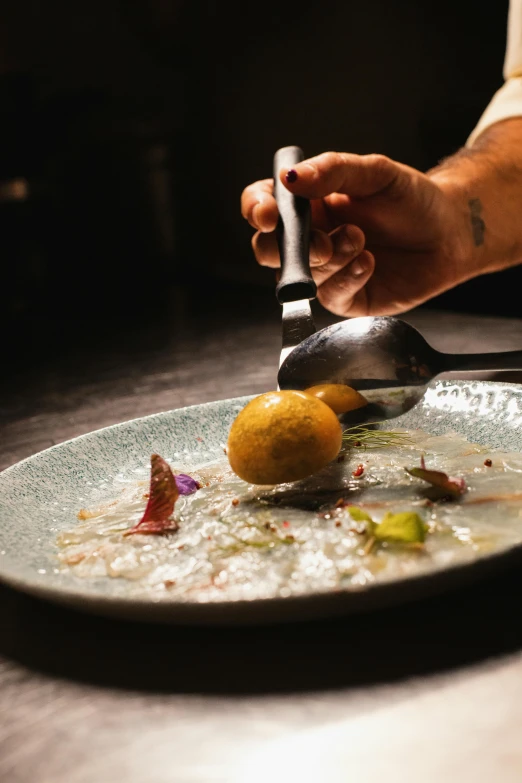 this person is using a small cheese grater to scoop some food