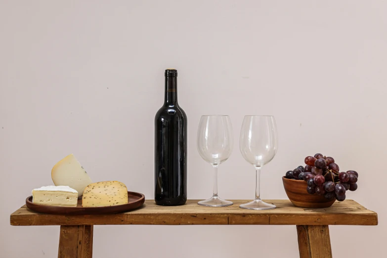 wine, cheese and gs are lined up on the table