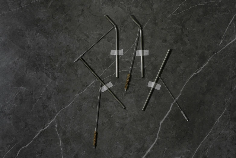 two tooth brushes and an arrow on a marble surface