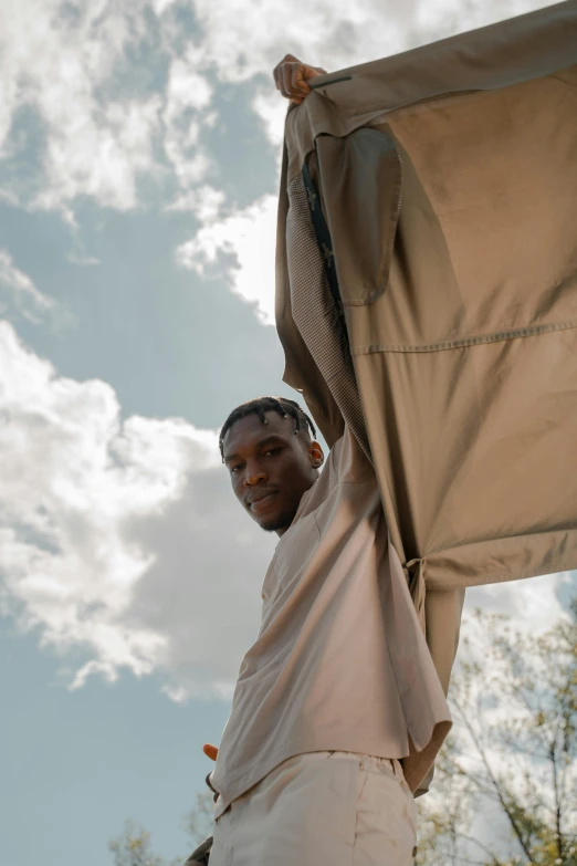 a man holds an umbrella under his arm