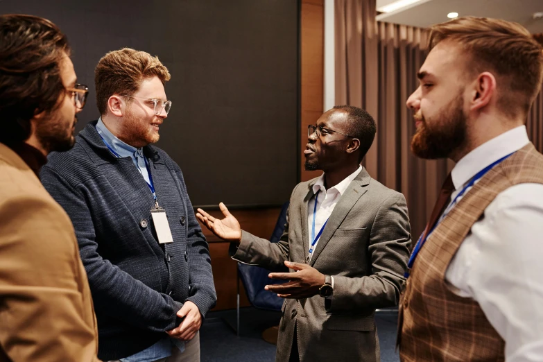 three men are discussing in front of a conference room