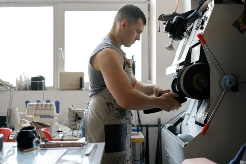 a man working on a machine inside a shop