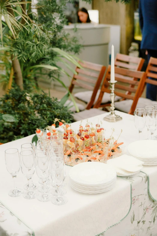 many empty plates are on a table with flowers and other decorations