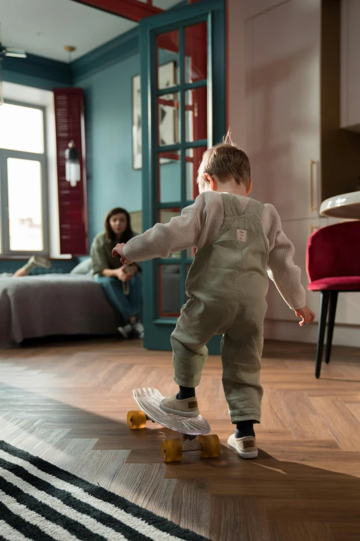 a little boy wearing some kind of outfit on a skateboard