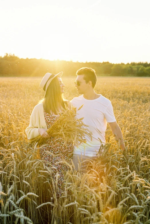 a man and a woman are in a field holding soing