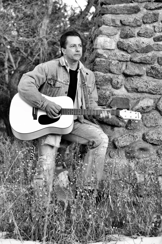 black and white pograph of man playing guitar