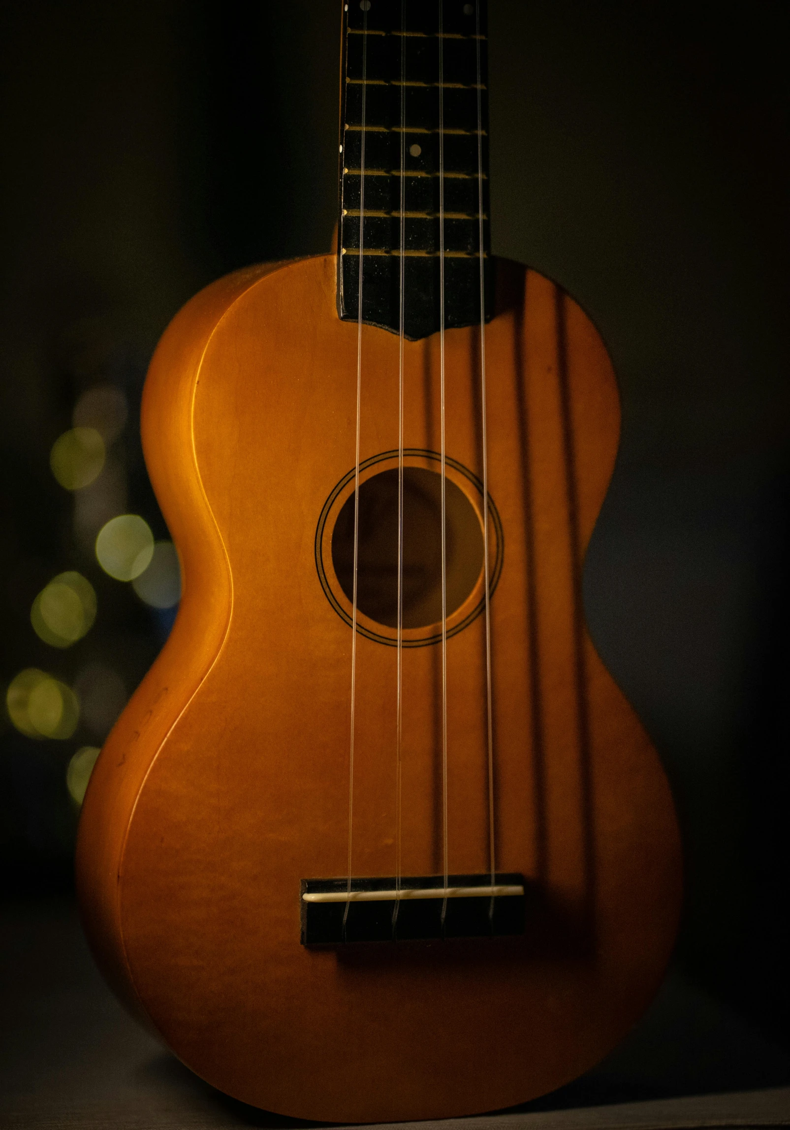 an orange ukulele is placed on a table