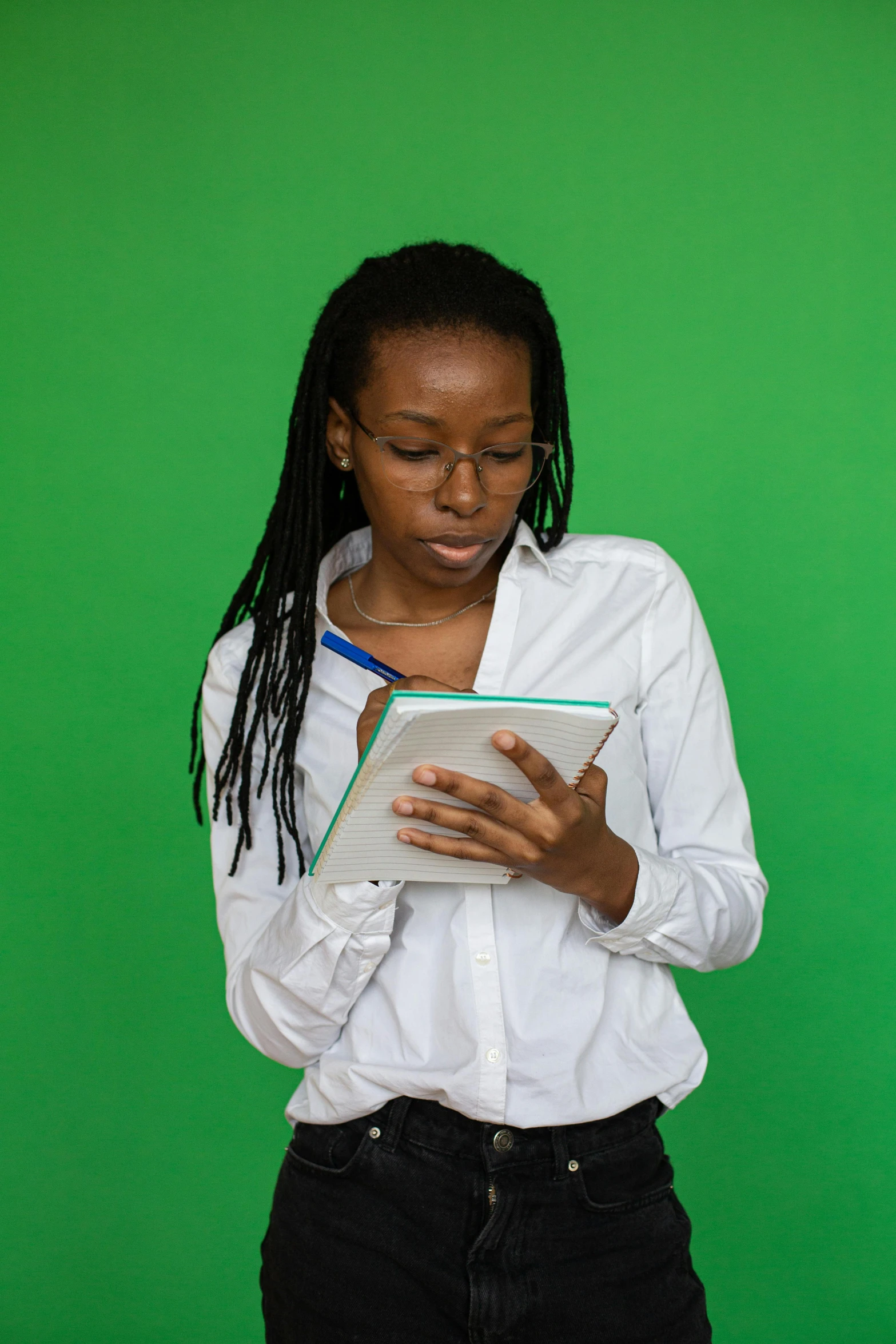 a black woman with long hair is holding a book