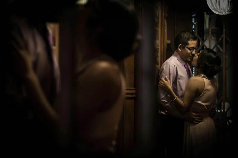 two people in formal wear, one holding a knife