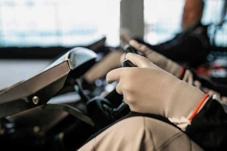 a hand on a dashboard with some gloves on