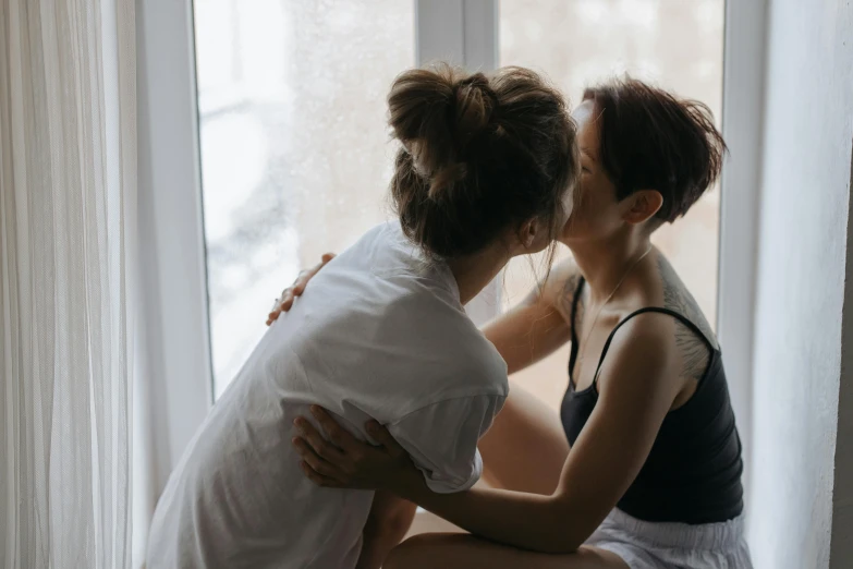 two women touching each other and holding their faces