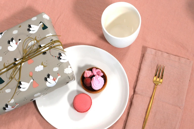 a plate of food with two candy and a wrapped gift