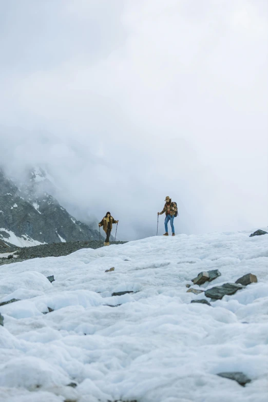 two men walking down the side of a snowy hill