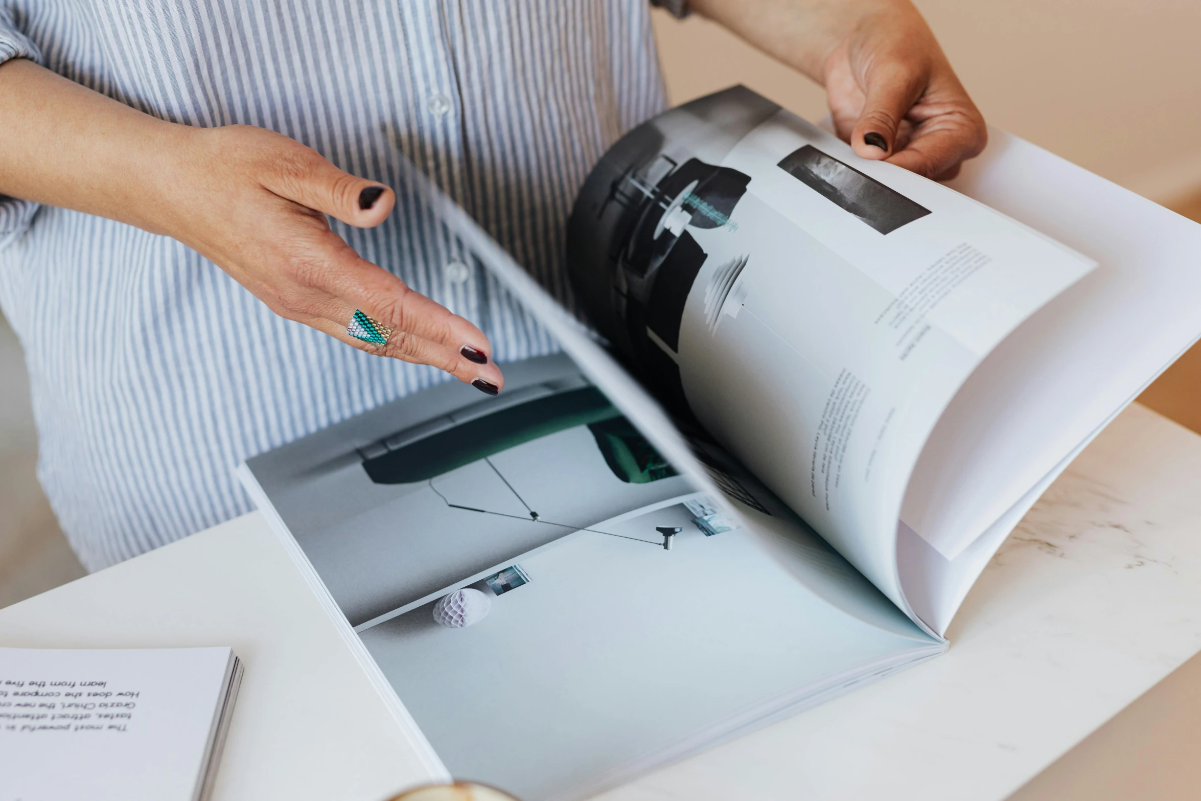 a woman is shown holding the pages of a magazine