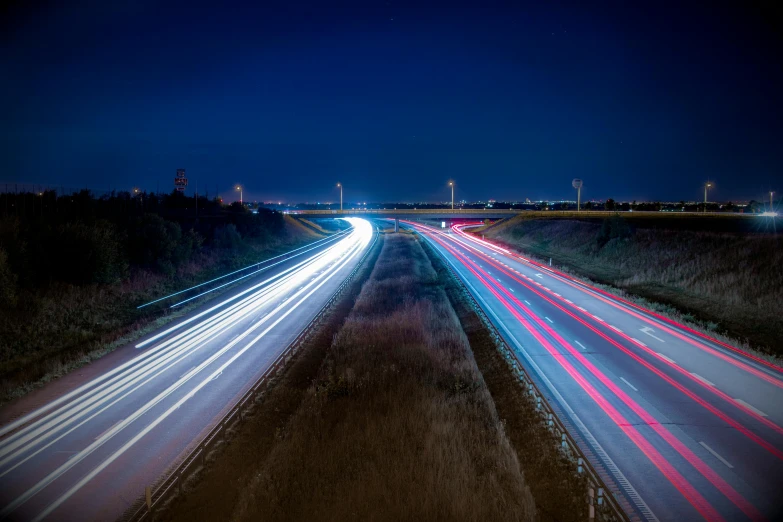 a highway at night with lots of traffic going by