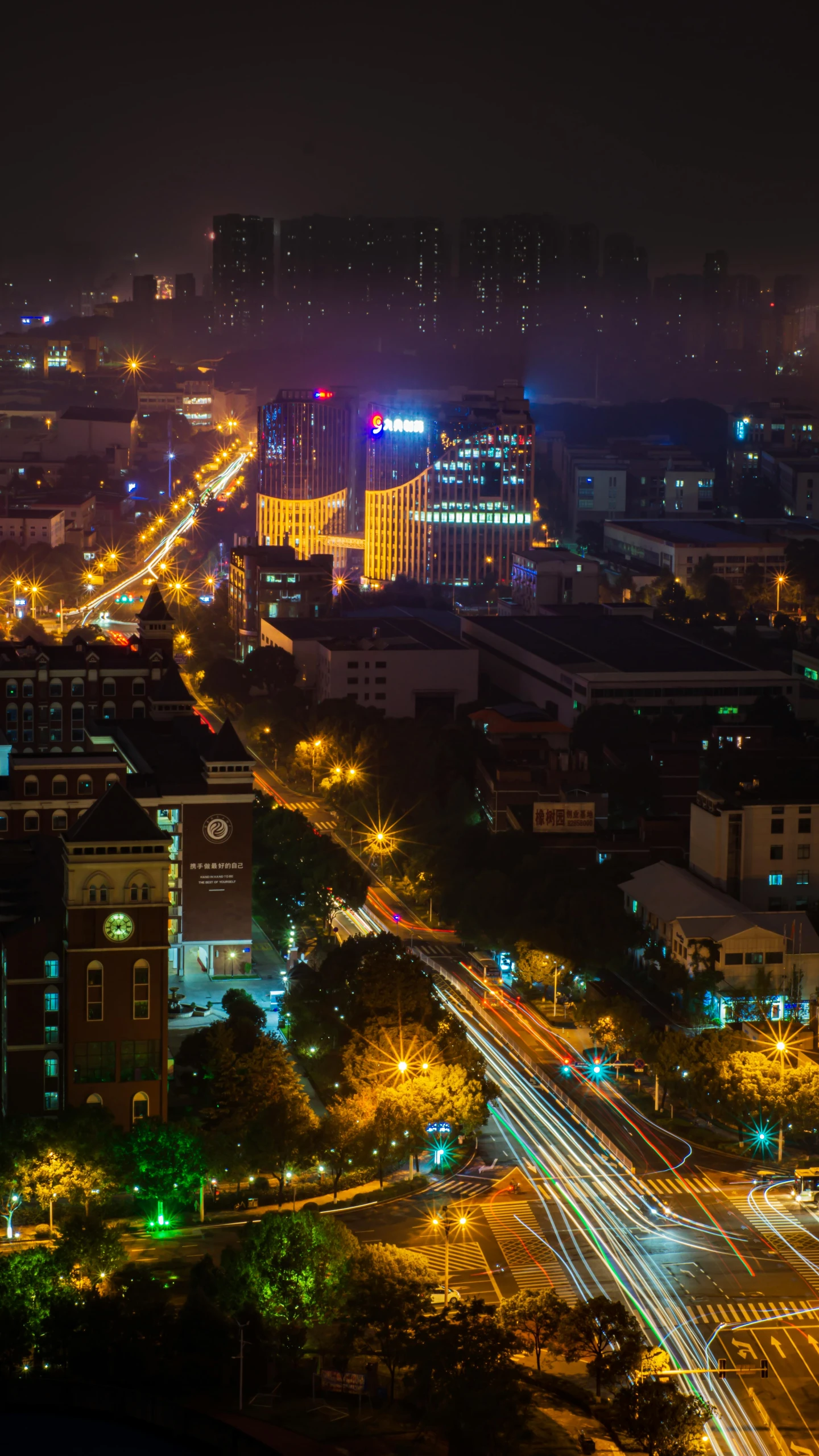 a city street is lit up with brightly colored lights