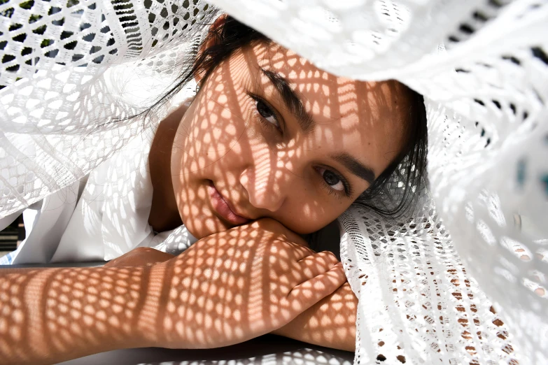 a woman with an intricate white cover covering her face