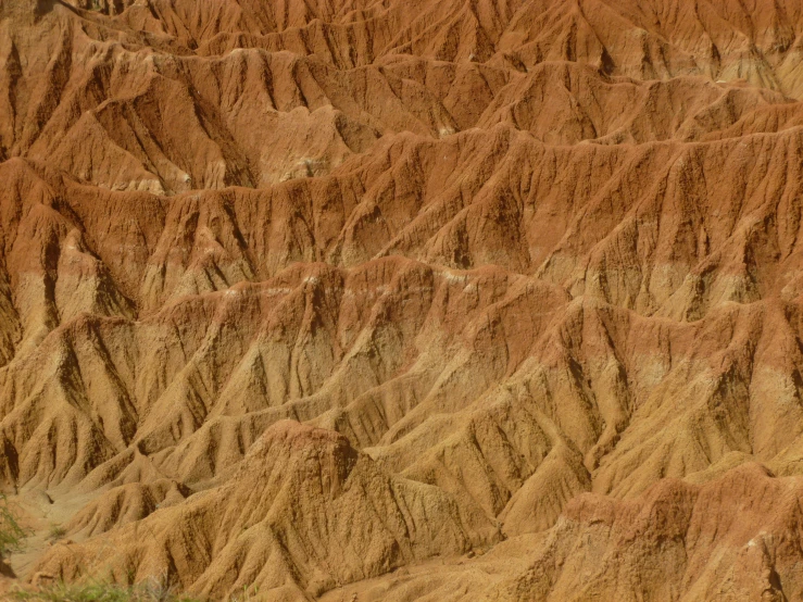 a yellow and brown mountain in the desert