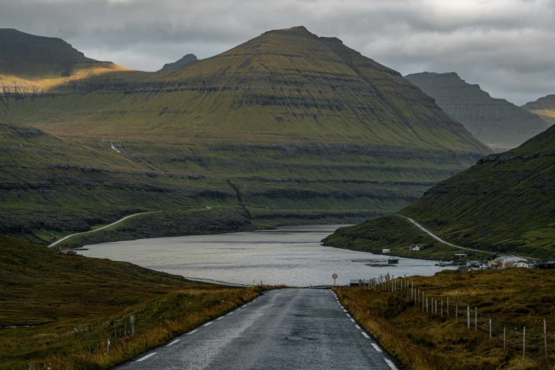 the road to  is empty and surrounded by mountains