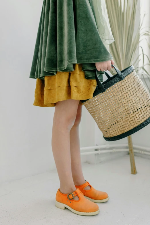 a woman with a wicker basket holding an orange pair