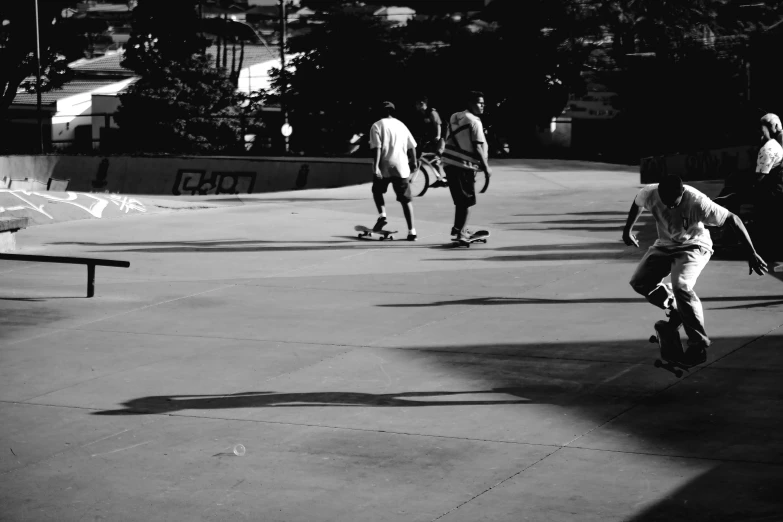 a group of people skateboard down a ramp