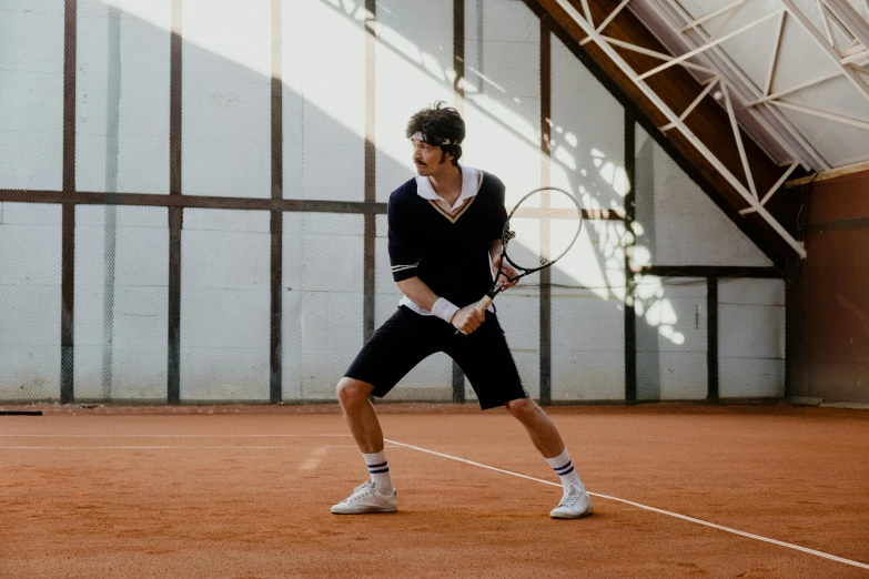 a man holding a tennis racquet on top of a tennis court