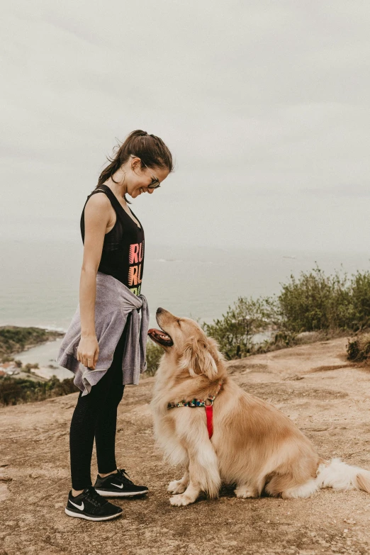 a girl and her dog on a windy day