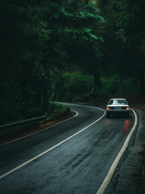 a car driving down the highway in the rain